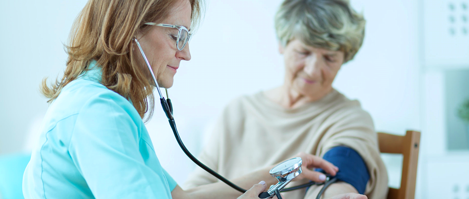caregiver checking blood pressure